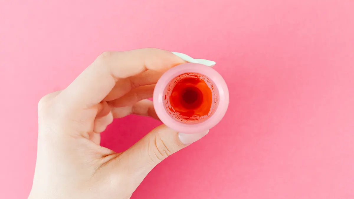 Top view of a menstrual cup with red liquid